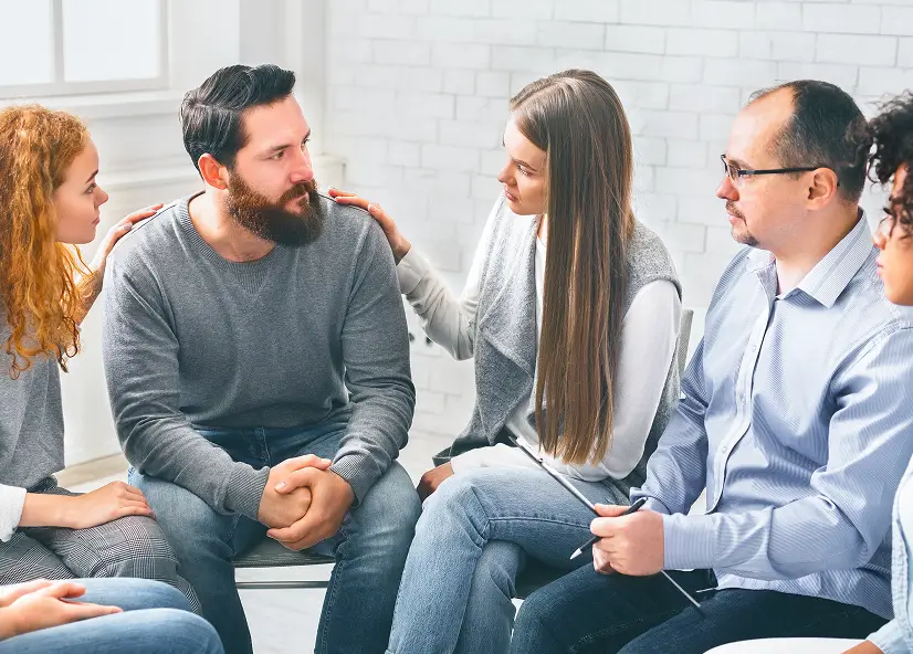 people having aa meeting in recovery center