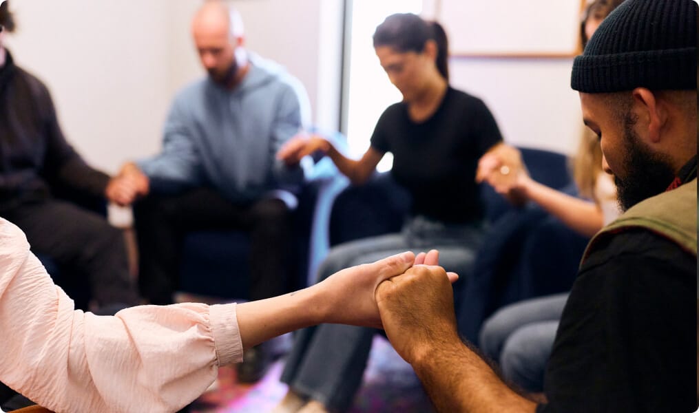 people holding hands each other in a circle