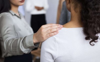 woman consoling person group therapy session